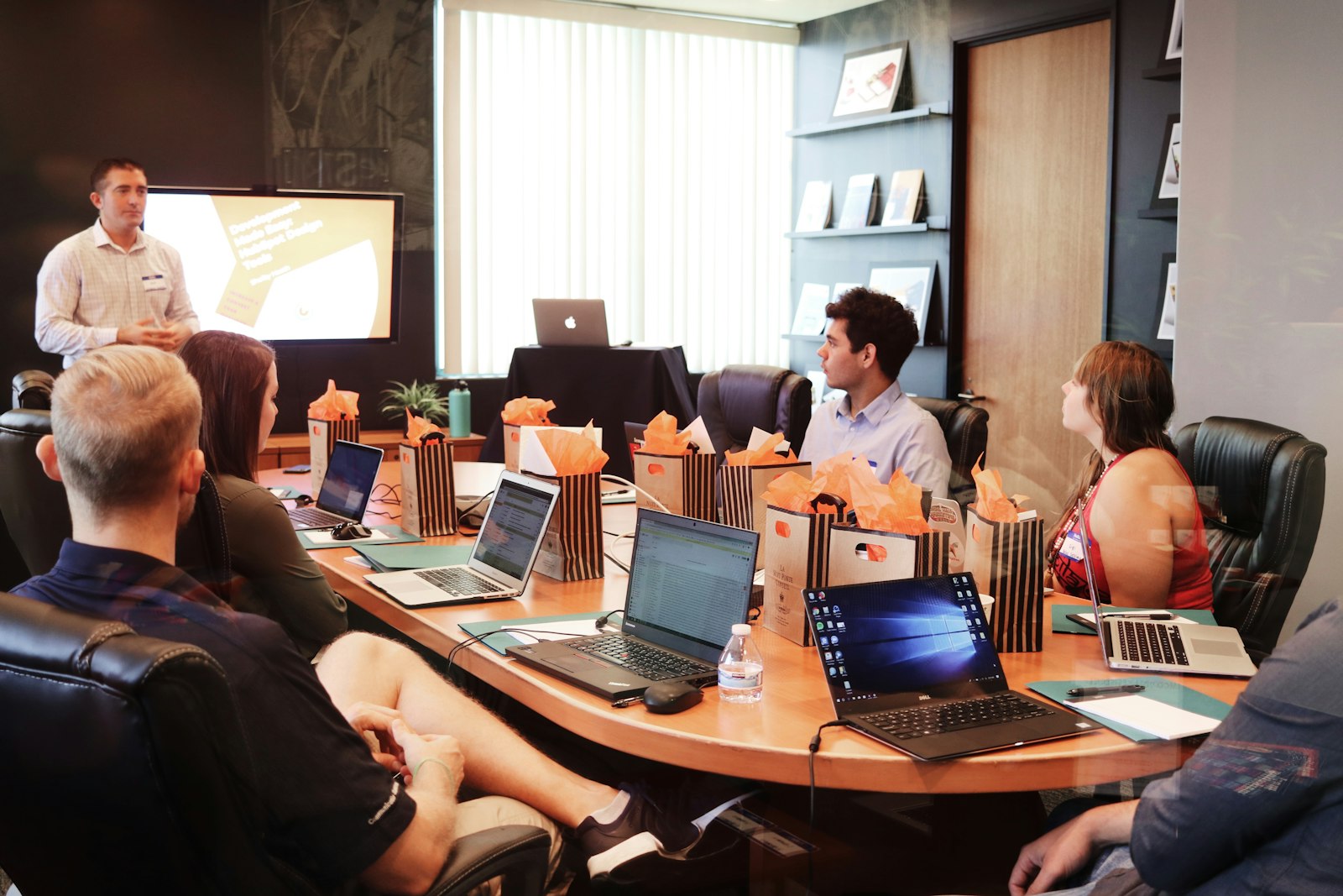 A research desk with a laptop, notebooks and charts laid out for reviewing model performance
